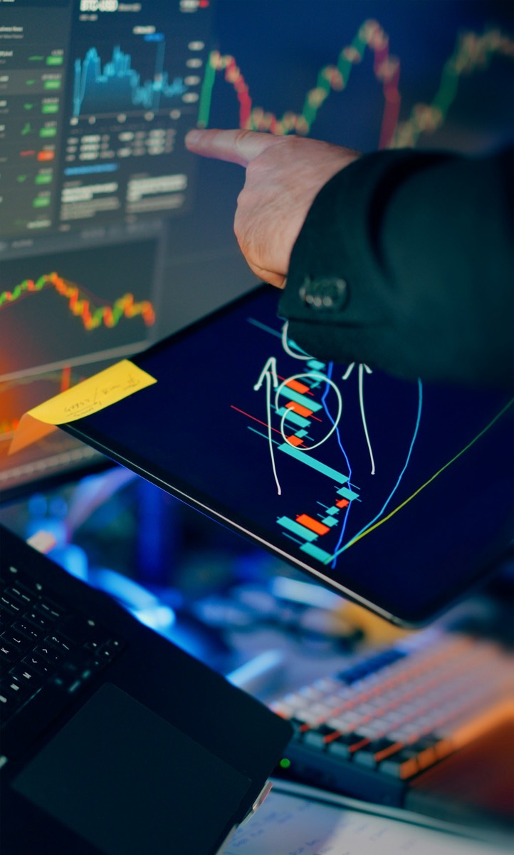 Analyst reviewing charts on a tablet before the market opens